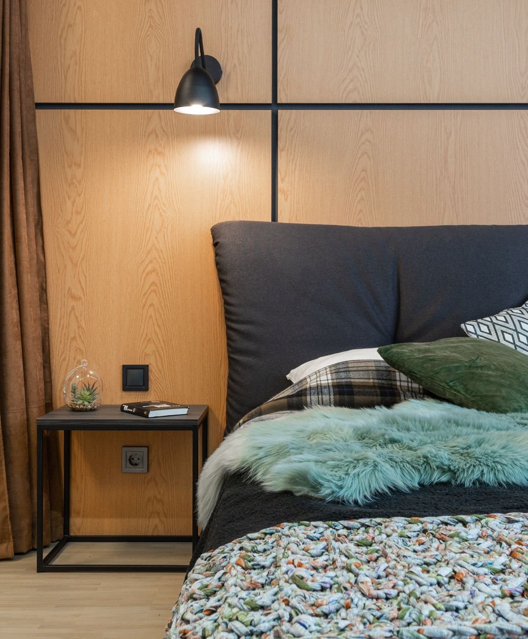 bed with cushions near wall